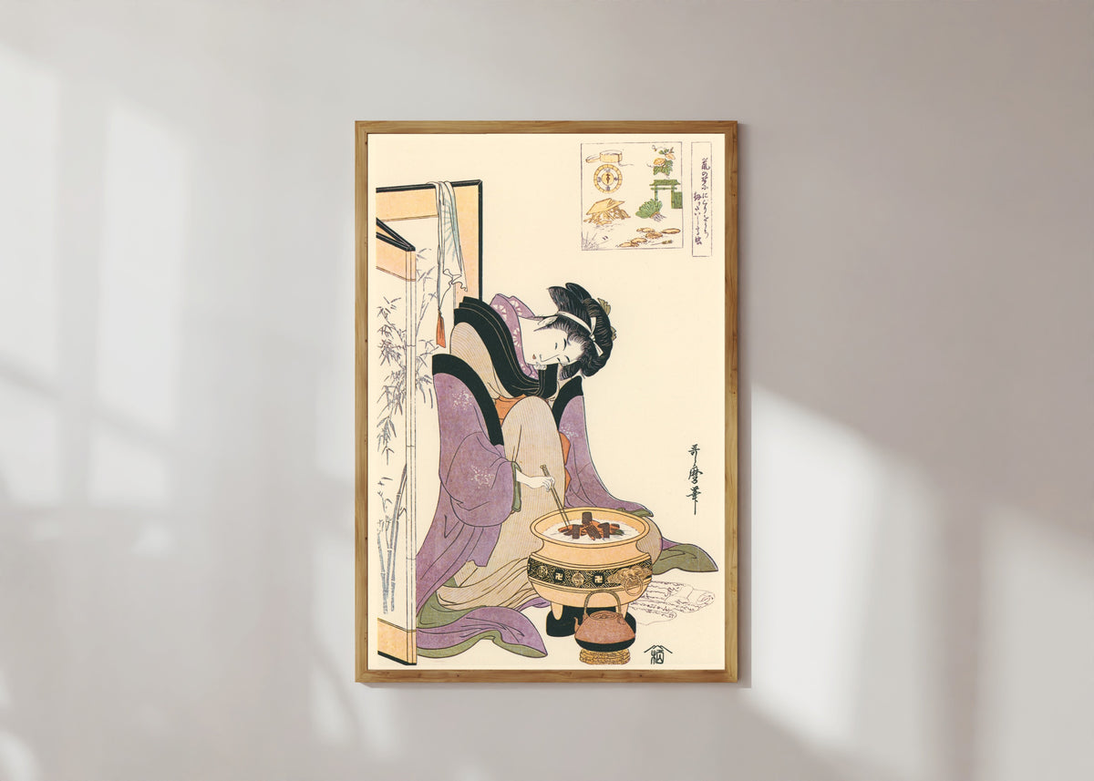 Framed art print of Okita of Naniwaya, before a Brazier by Kitagawa Utamaro, in a light wood frame on a sunlit white wall