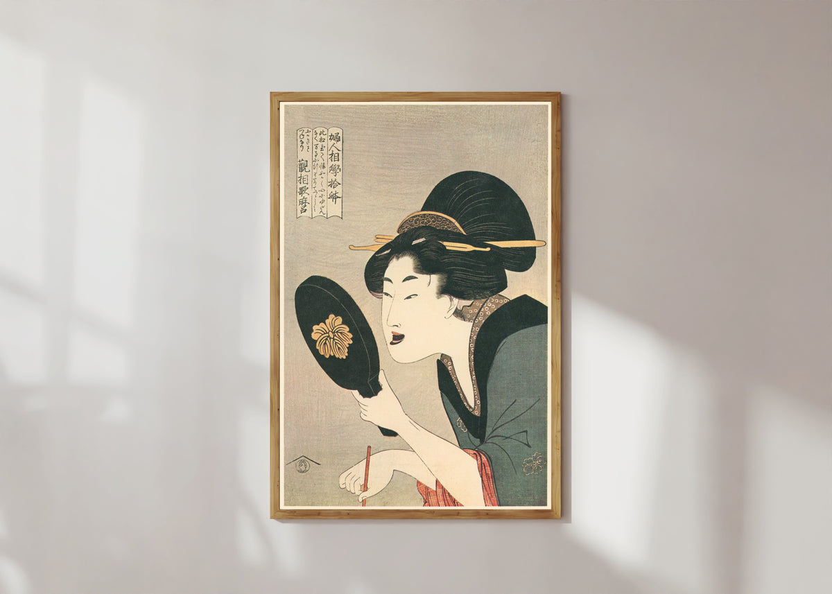 Framed art print of Ten Physiognomic Aspects of Women: Dyeing the Teeth by Kitagawa Utamaro, in a light wood frame on a sunlit white wall