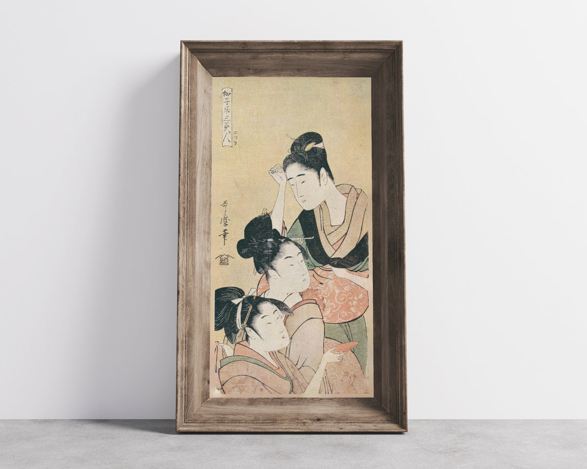 Three Beauties at a Playhouse by Kitagawa Utamaro — shown framed on a wall