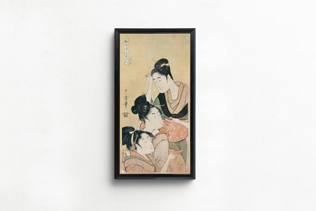 Three Beauties at a Playhouse by Kitagawa Utamaro — shown framed on a wall