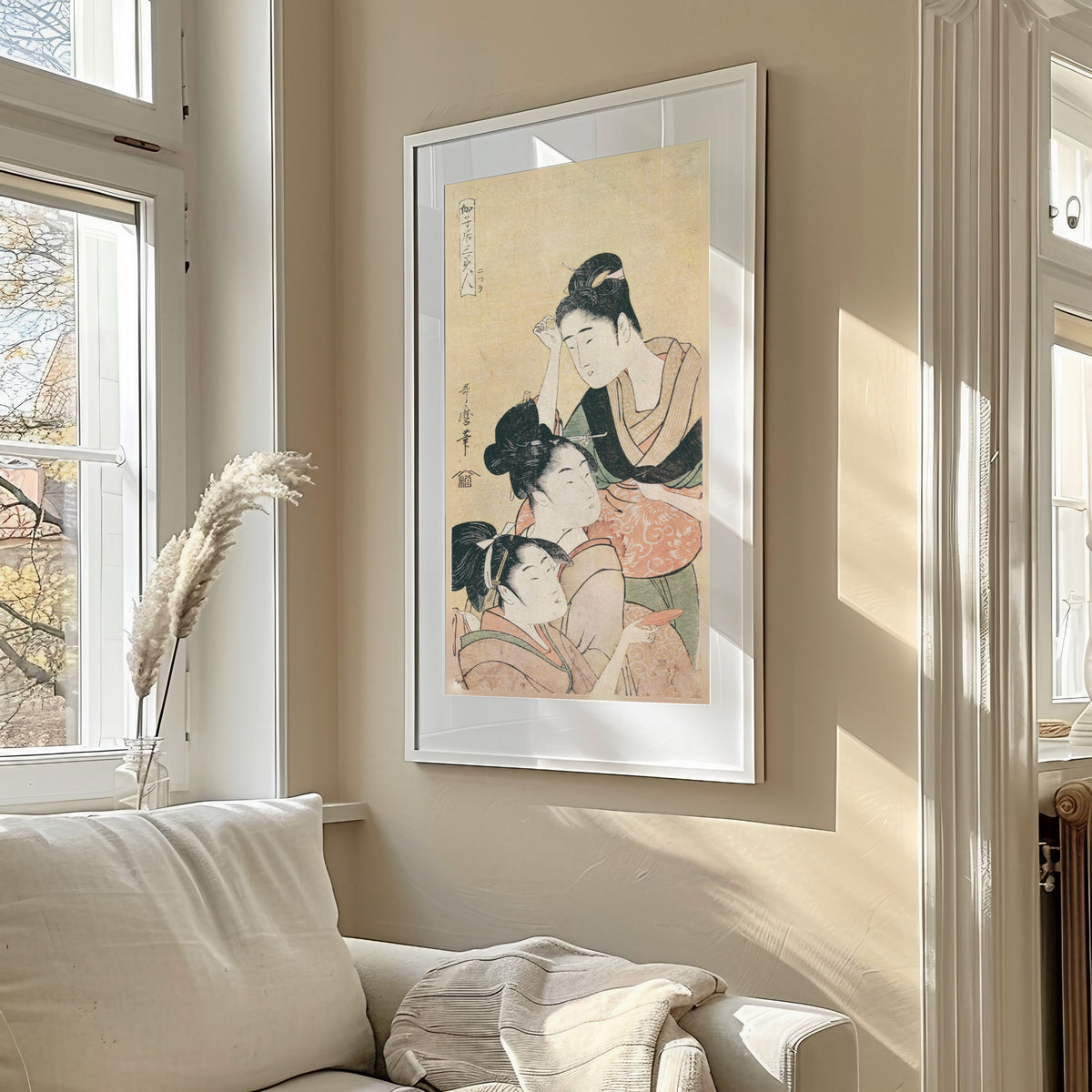 Three Beauties at a Playhouse by Kitagawa Utamaro — shown framed on a wall