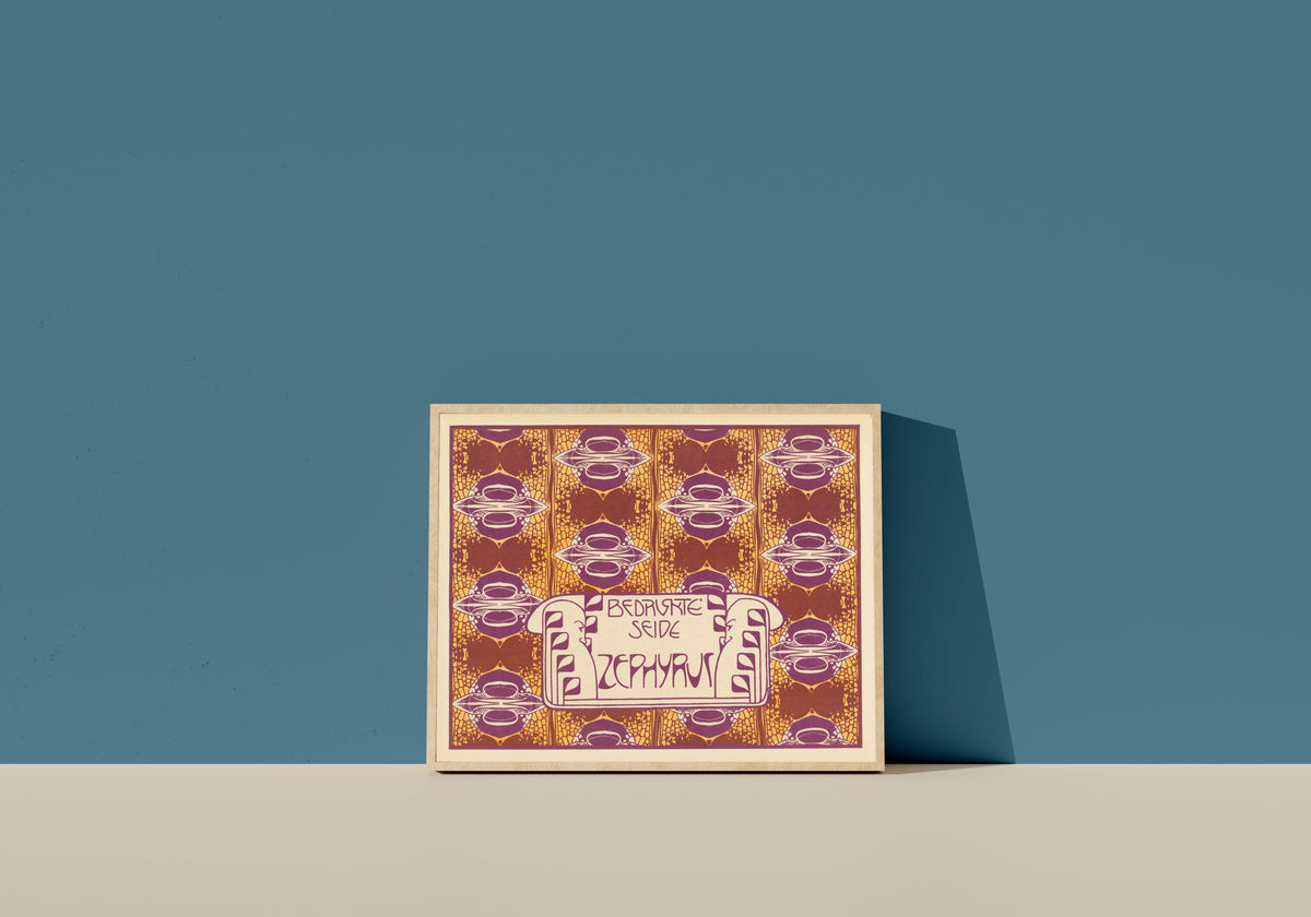 Framed art print of Bedruckte Seide Zephyrus (Zephyrus Printed Silk) by Koloman Moser, in a light wood frame leaning on a blue wall