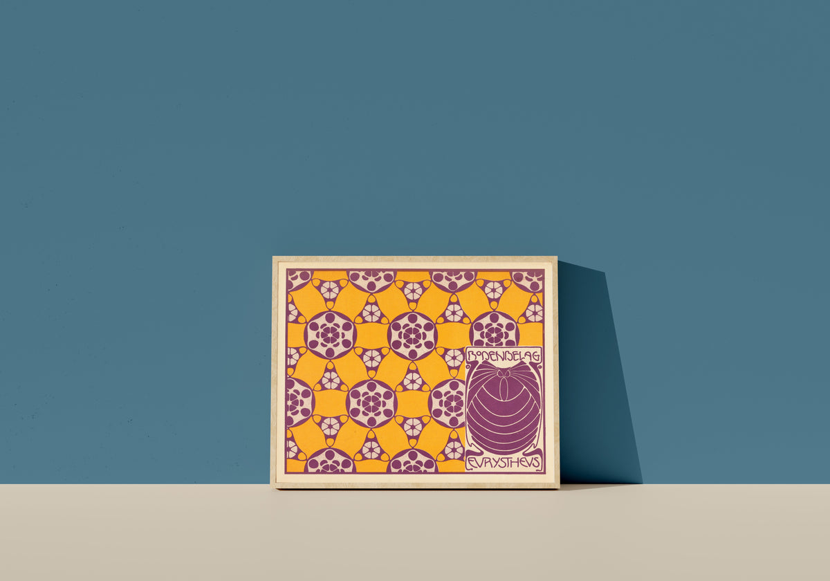 Framed art print of Bodenbelag Eurystheus (Eurystheus Floor Covering) by Koloman Moser, in a light wood frame leaning on a blue wall