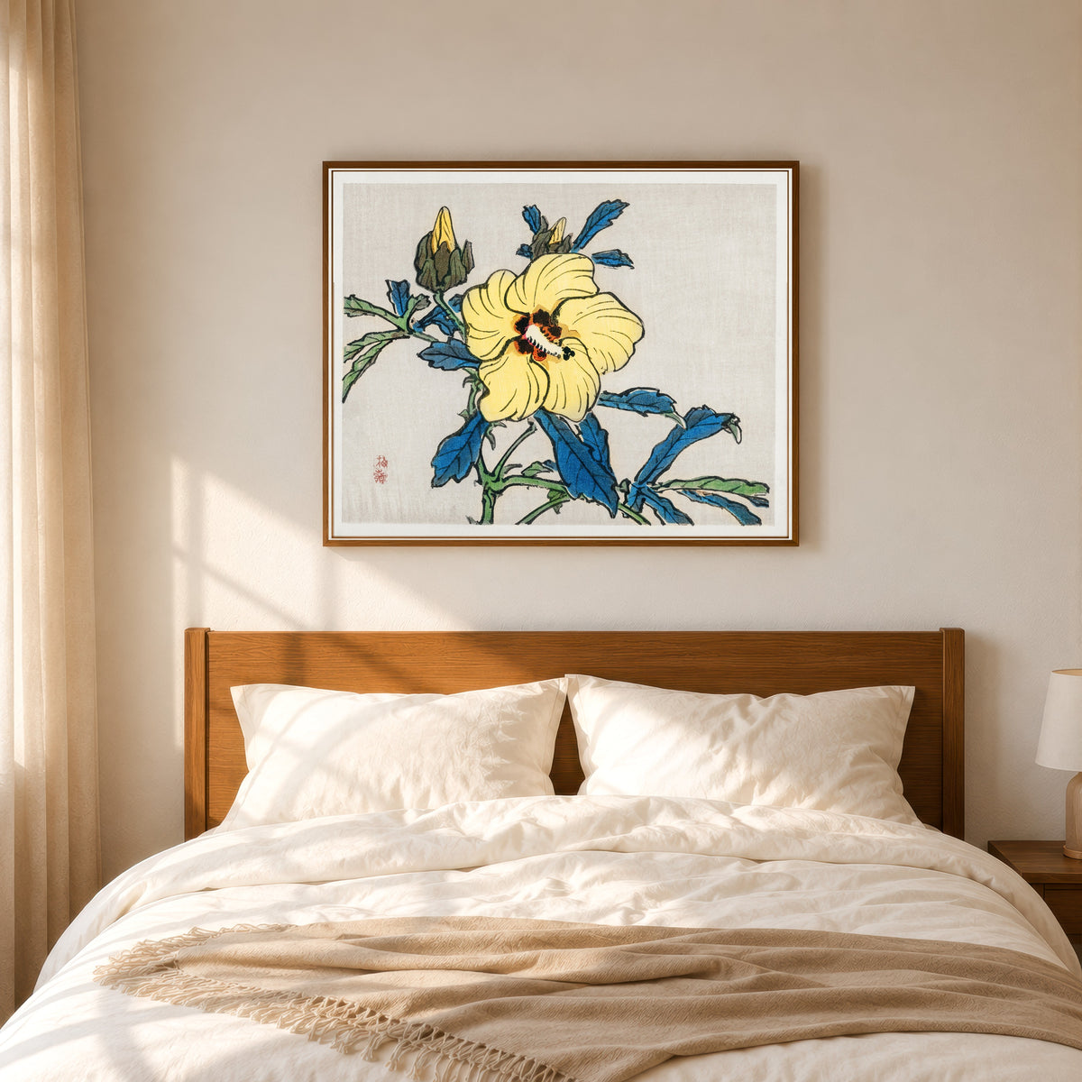 Framed art print of Hibiscus by Kono Bairei, in a slim wood frame above a bed in a sunlit bedroom