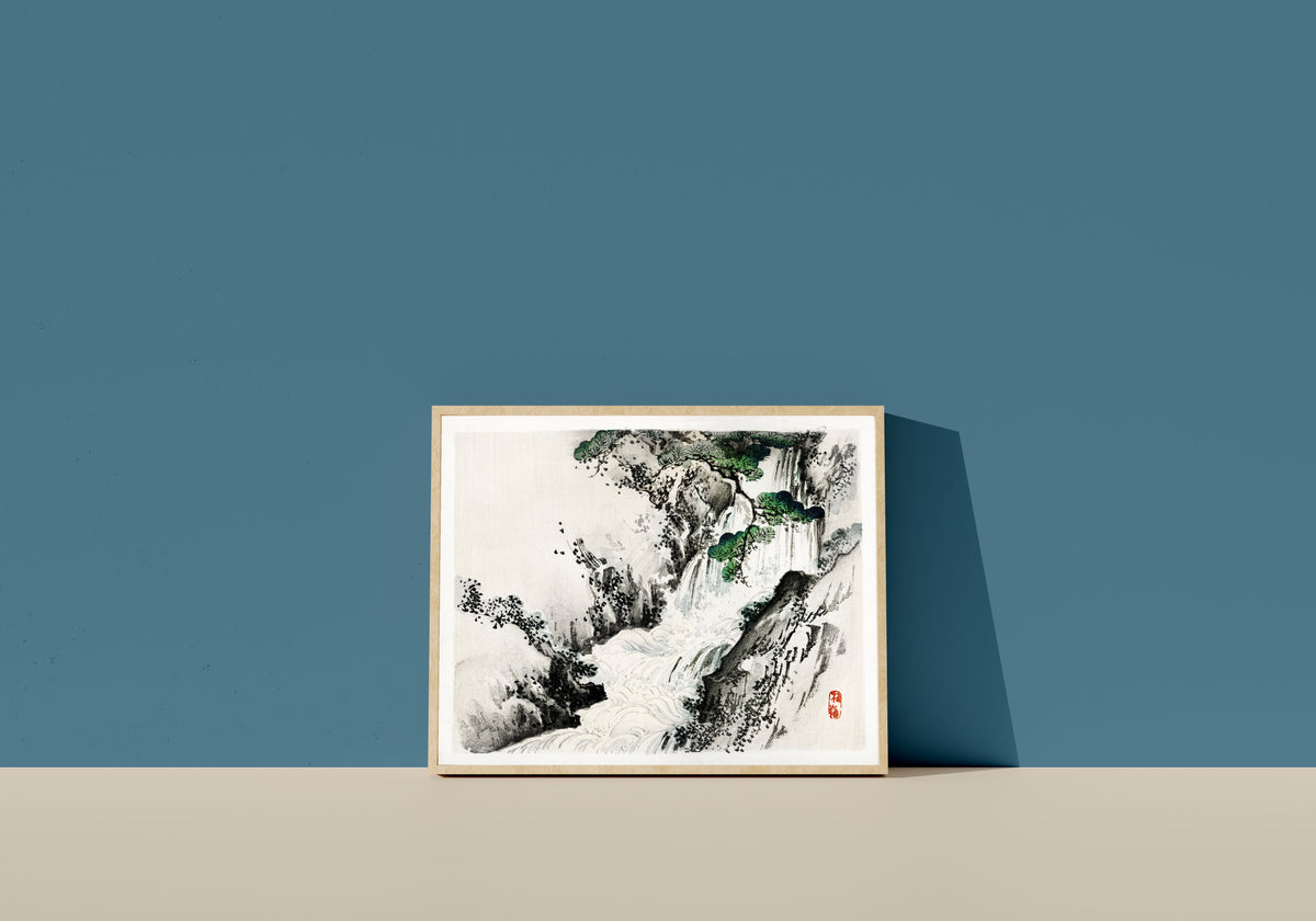Framed art print of Waterfall by Kōno Bairei, in a light wood frame leaning on a blue wall
