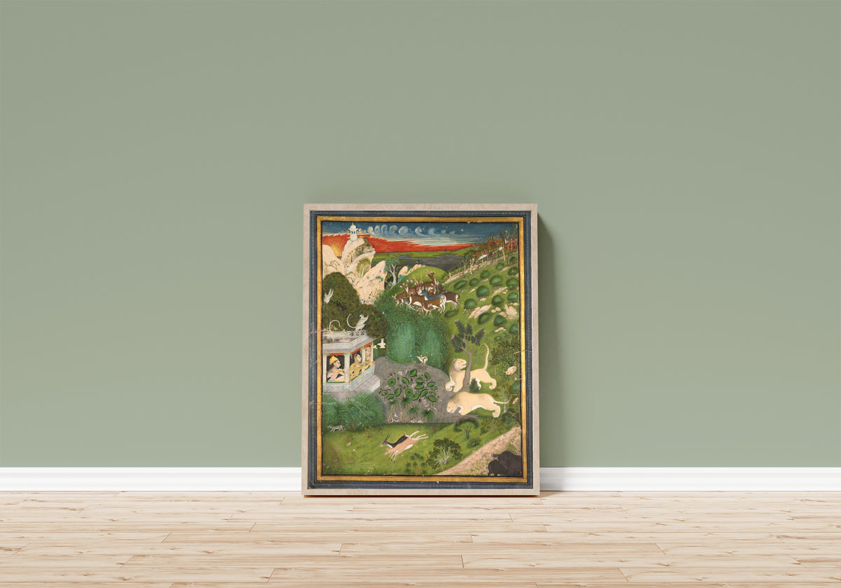 Framed art print of Royal Women Shooting from a Pavilion by Kota school, in a light wood frame leaning on a sage green wall above a wooden floor