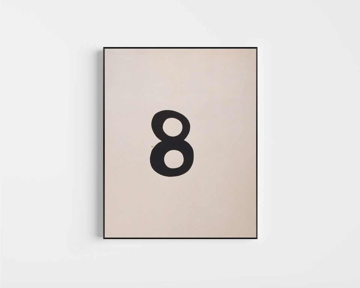 Framed art print of Arabische Acht by Kurt Schwitters, in a slim black frame on a plain white wall