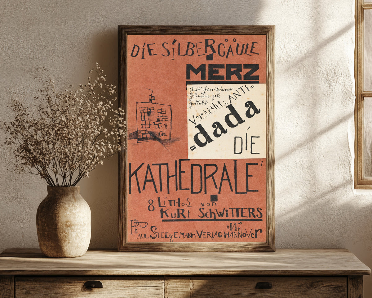 Framed art print of Die Kathedrale (Die Silbergäule) by Kurt Schwitters, in a dark wood frame leaning on a rustic console beside dried flowers