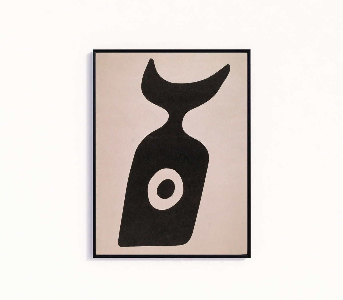 Framed art print of Die Nabelflasche by Kurt Schwitters, in a slim black frame on a plain white wall