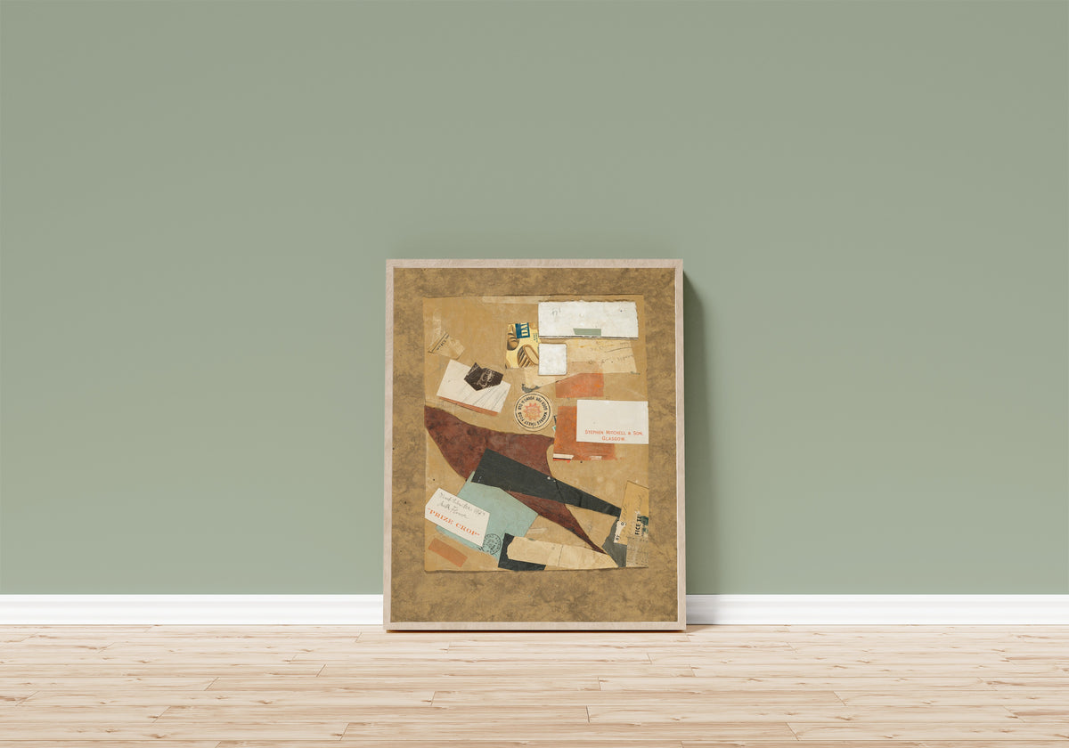 Framed art print of Milk Flower by Kurt Schwitters, in a light wood frame leaning on a sage green wall above a wooden floor