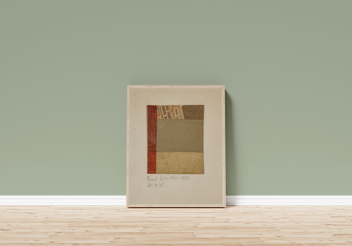 Framed art print of Mz 30, 45 by Kurt Schwitters, in a light wood frame leaning on a sage green wall above a wooden floor