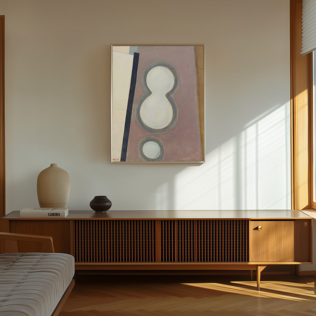 Framed art print of Ohne Titel (Acht) by Kurt Schwitters, in a thin light frame on a sunlit wall above a wooden sideboard