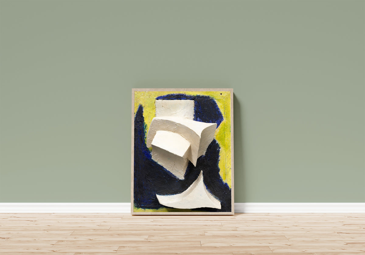 Framed art print of Ohne Titel (Bewegtes Weiss auf Blau und Gelb) by Kurt Schwitters, in a light wood frame leaning on a sage green wall above a wooden floor