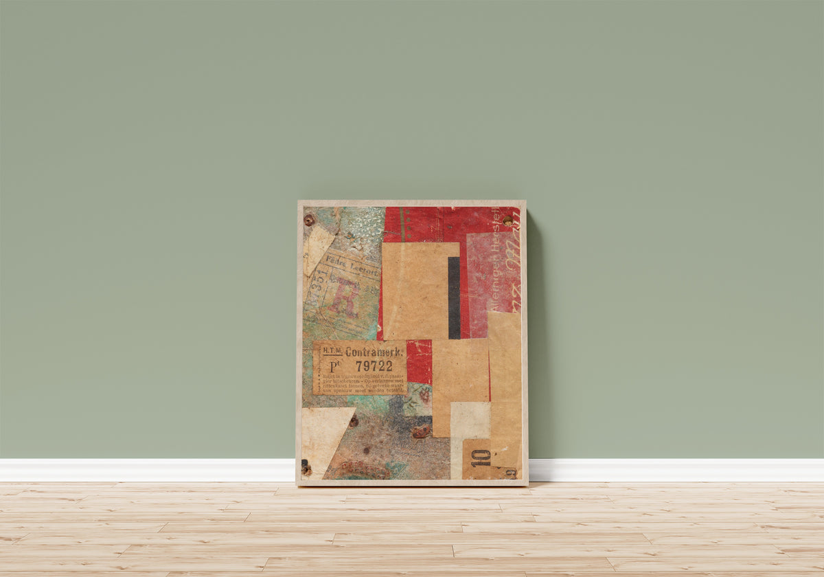 Framed art print of Ohne Titel (Contramerk.) by Kurt Schwitters, in a light wood frame leaning on a sage green wall above a wooden floor