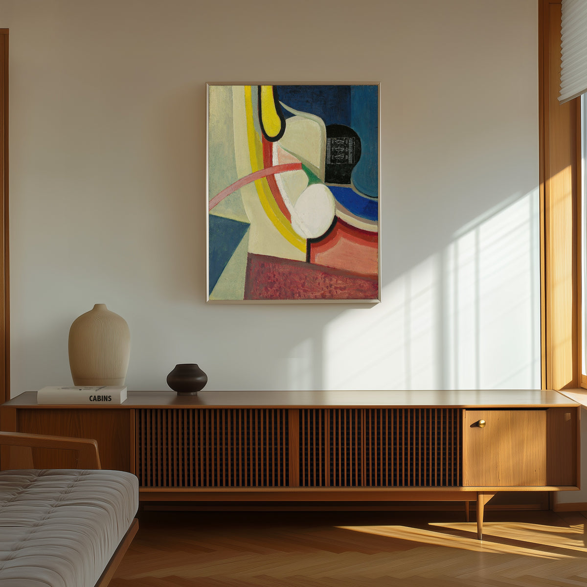Framed art print of Ohne Titel (Gute Laune) by Kurt Schwitters, in a thin light frame on a sunlit wall above a wooden sideboard