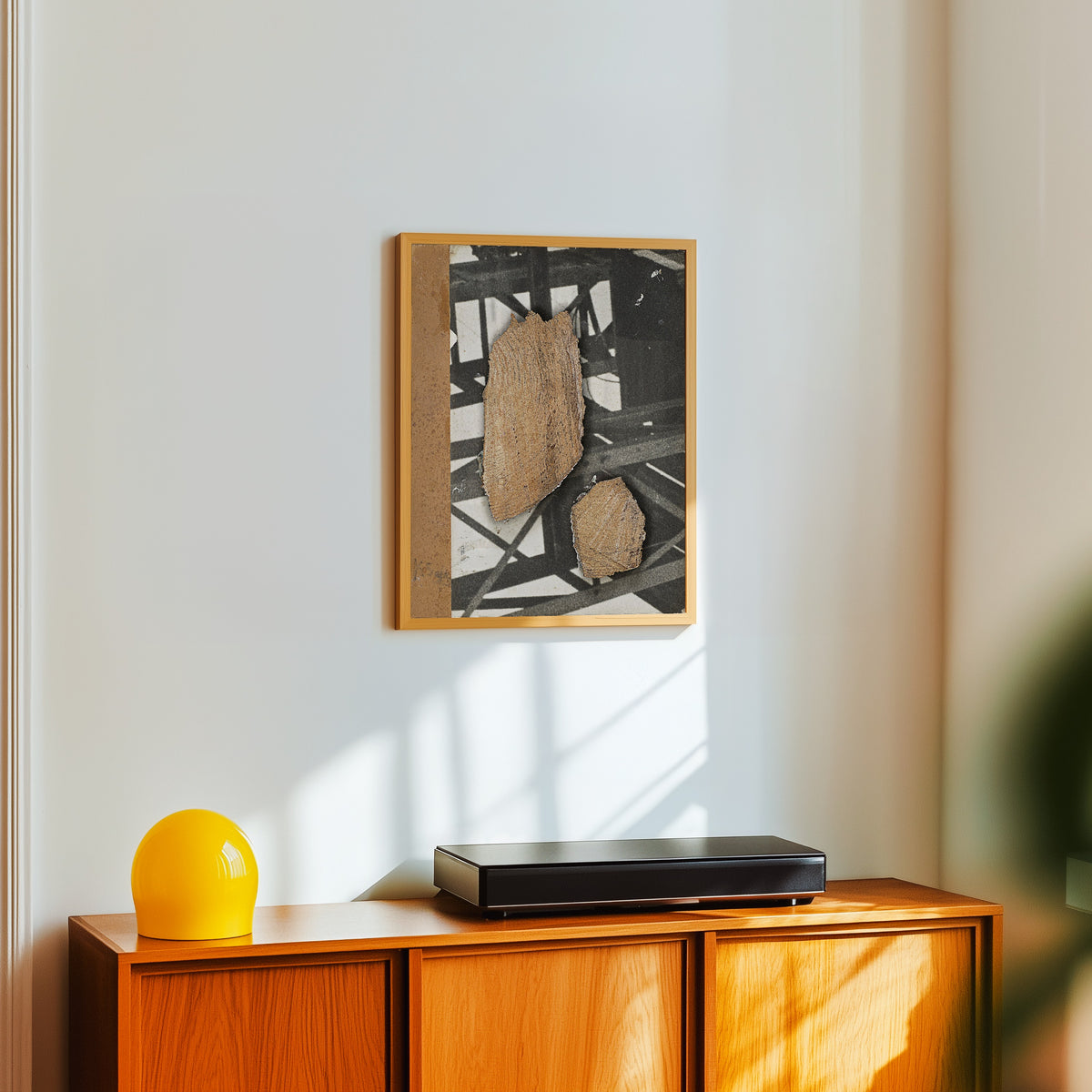 Framed art print of Ohne Titel (Mit Stahlträgerkonstruktion) by Kurt Schwitters, in a light wood frame on a white wall above an orange sideboard
