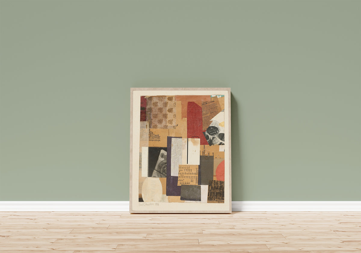 Framed art print of Ohne Titel (Oesie) by Kurt Schwitters, in a light wood frame leaning on a sage green wall above a wooden floor