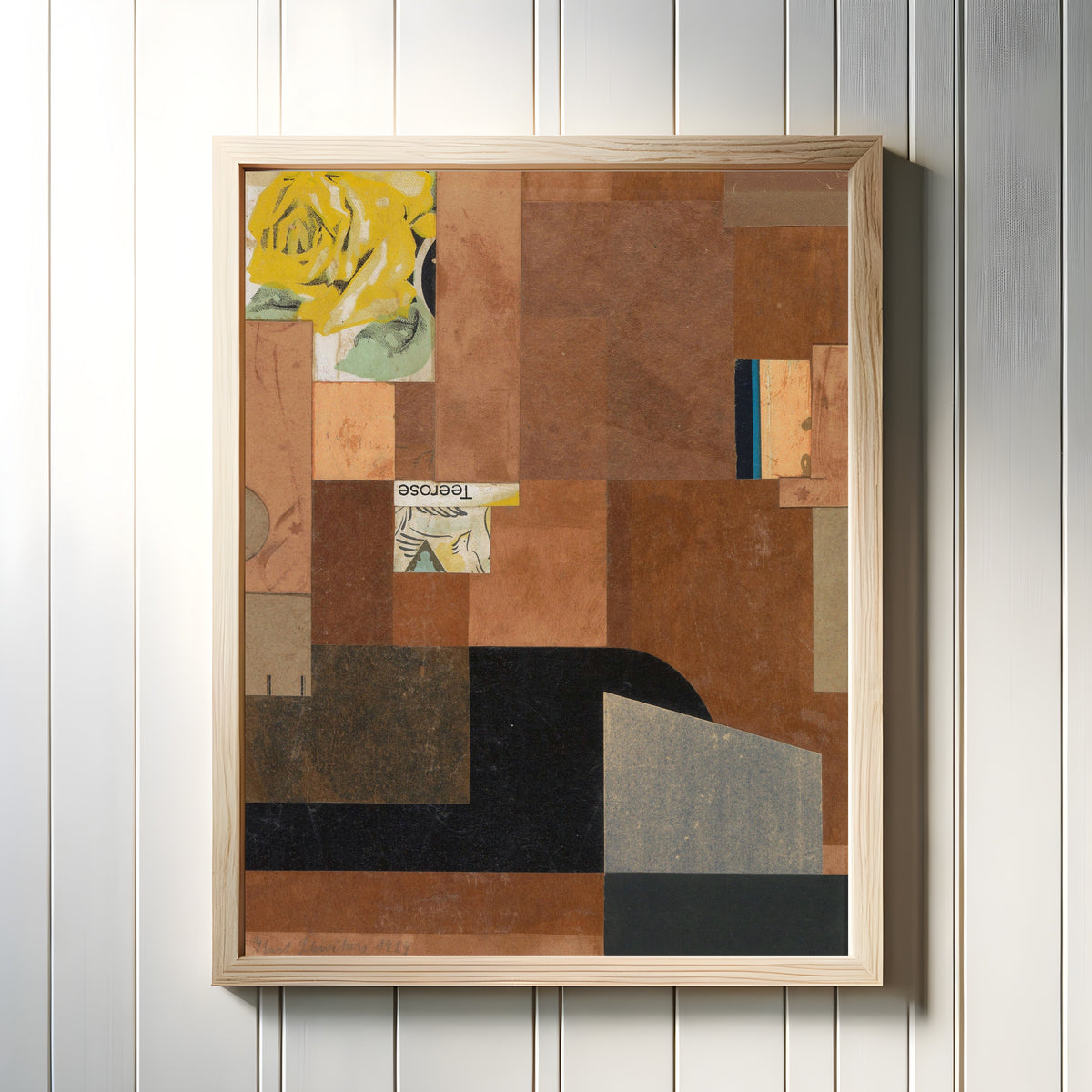 Framed art print of Tea Rose by Kurt Schwitters, in a light wood frame on a white panelled wall