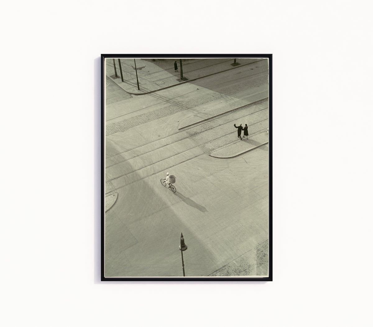 Framed art print of 7 A.M. (New Year's Morning) by László Moholy-Nagy, in a slim black frame on a plain white wall
