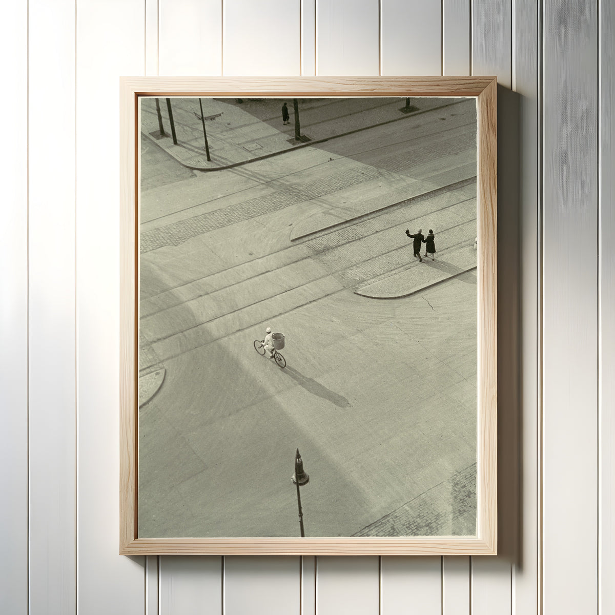 Framed art print of 7 A.M. (New Year's Morning) by László Moholy-Nagy, in a light wood frame on a white panelled wall