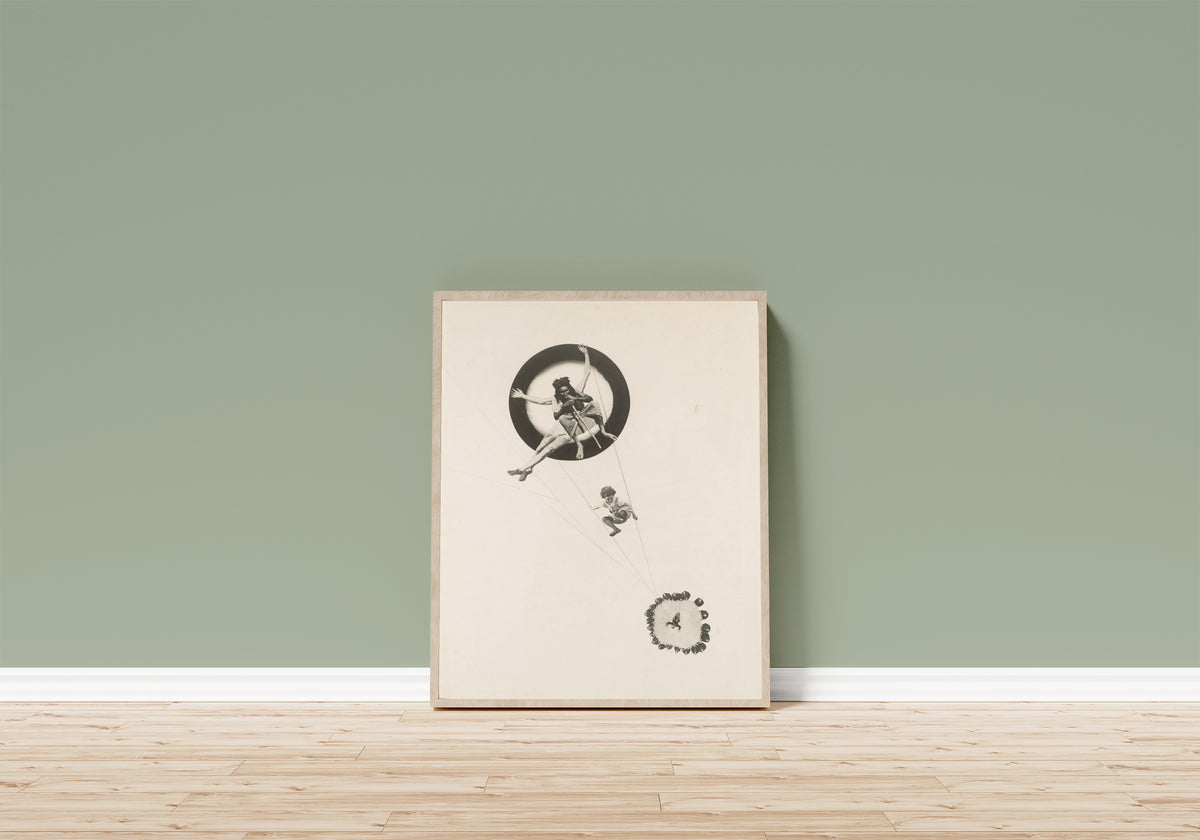Framed art print of Behind the Back of the Gods by László Moholy-Nagy, in a light wood frame leaning on a sage green wall above a wooden floor