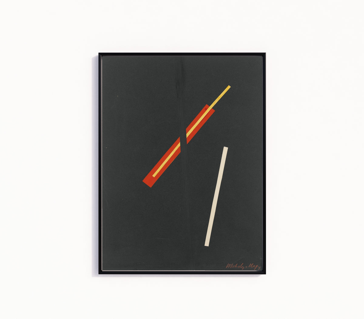 Framed art print of Collage with Three Elements by László Moholy-Nagy, in a slim black frame on a plain white wall