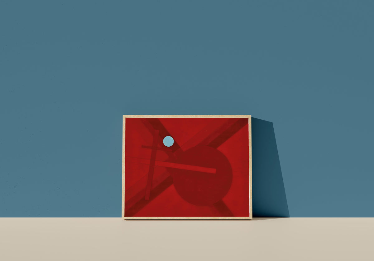 Framed art print of Composition G4 by László Moholy-Nagy, in a light wood frame leaning on a blue wall