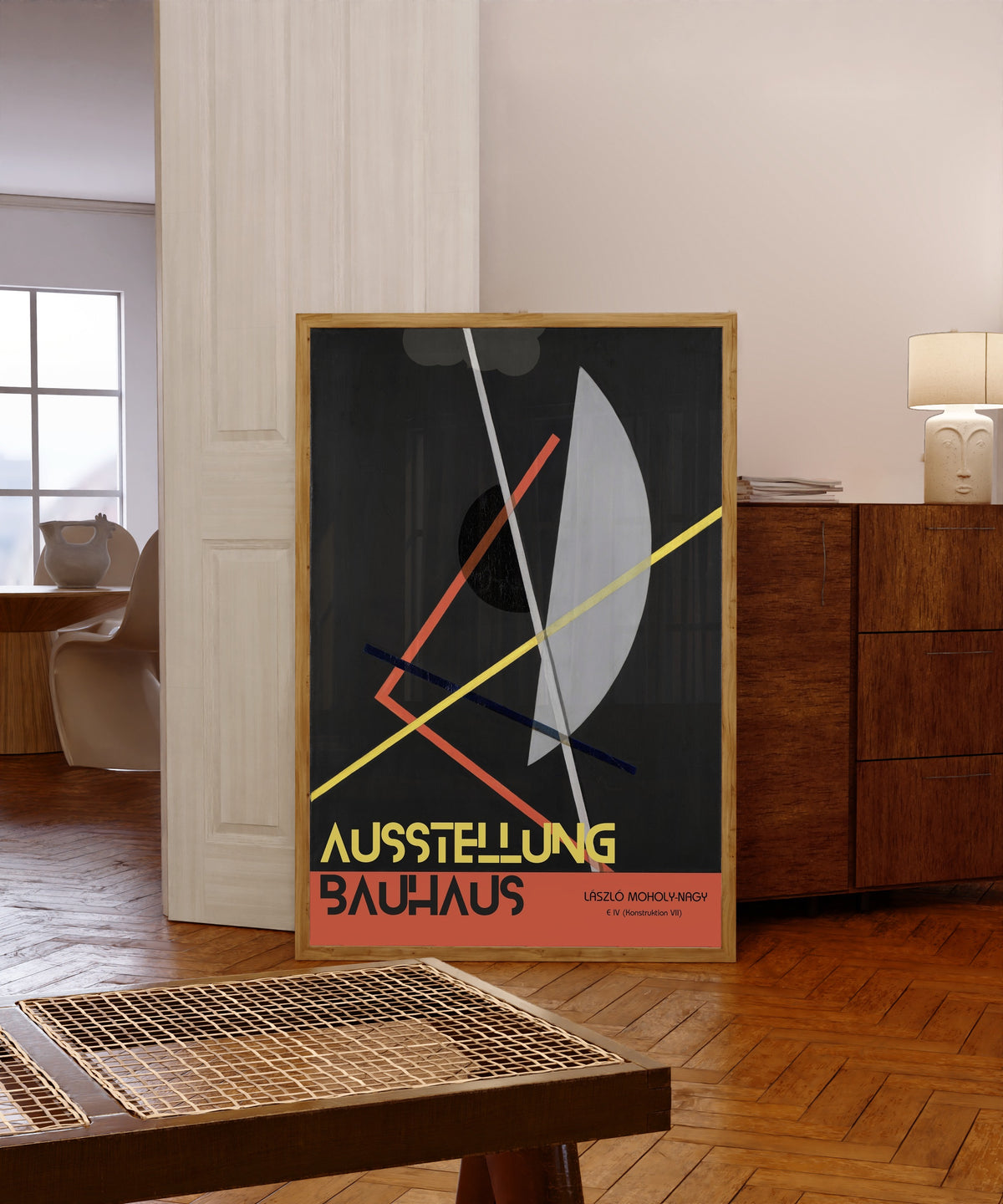 Framed art print of E IV (Konstruktion 8) by László Moholy-Nagy, in a light wood frame leaning in a warm room with a parquet floor