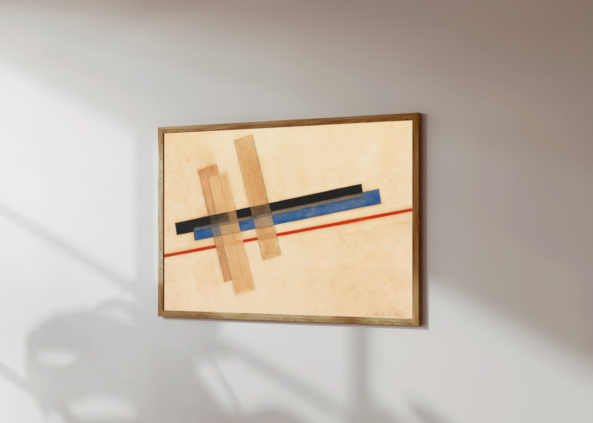 Framed art print of Komposition by László Moholy-Nagy, in a light wood frame on a sunlit white wall, seen at a slight angle