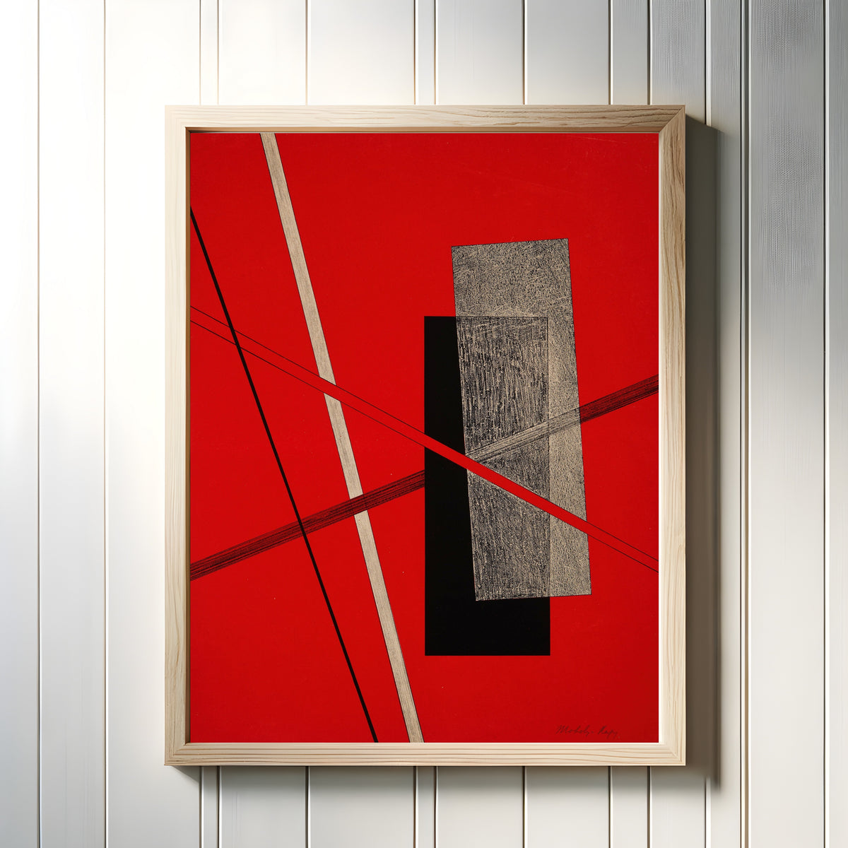Framed art print of Konstruktion IV by László Moholy-Nagy, in a light wood frame on a white panelled wall