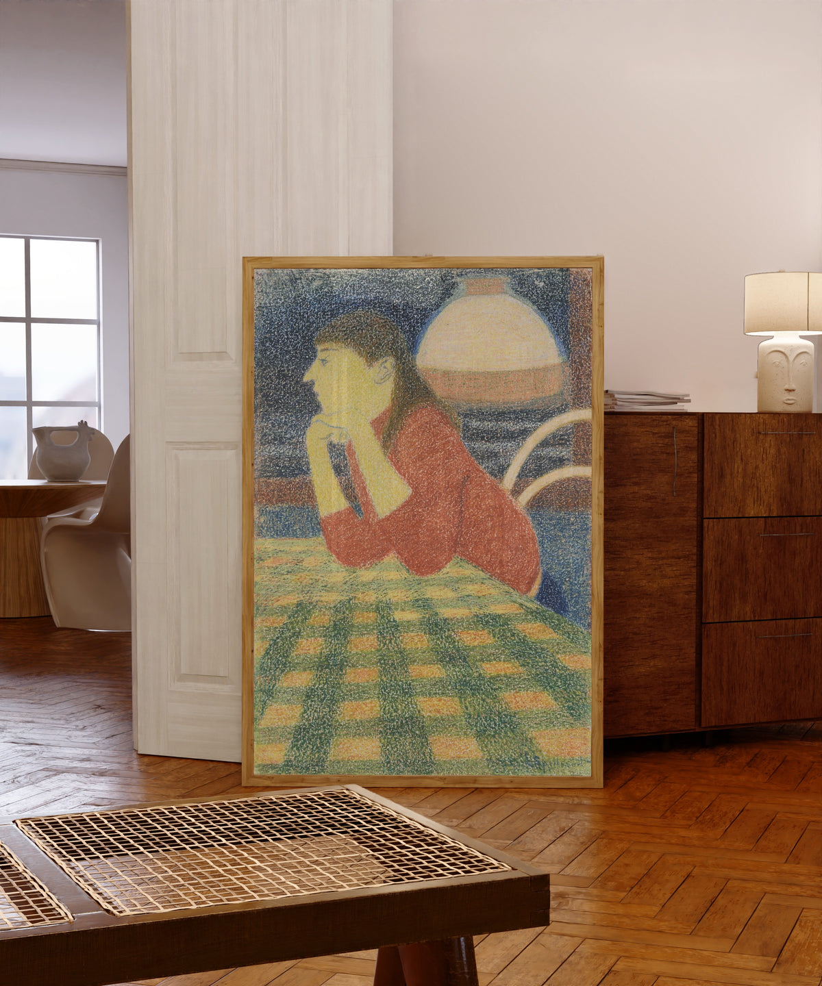 Framed art print of Leunende vrouw by Léon Spilliaert, in a light wood frame leaning in a warm room with a parquet floor