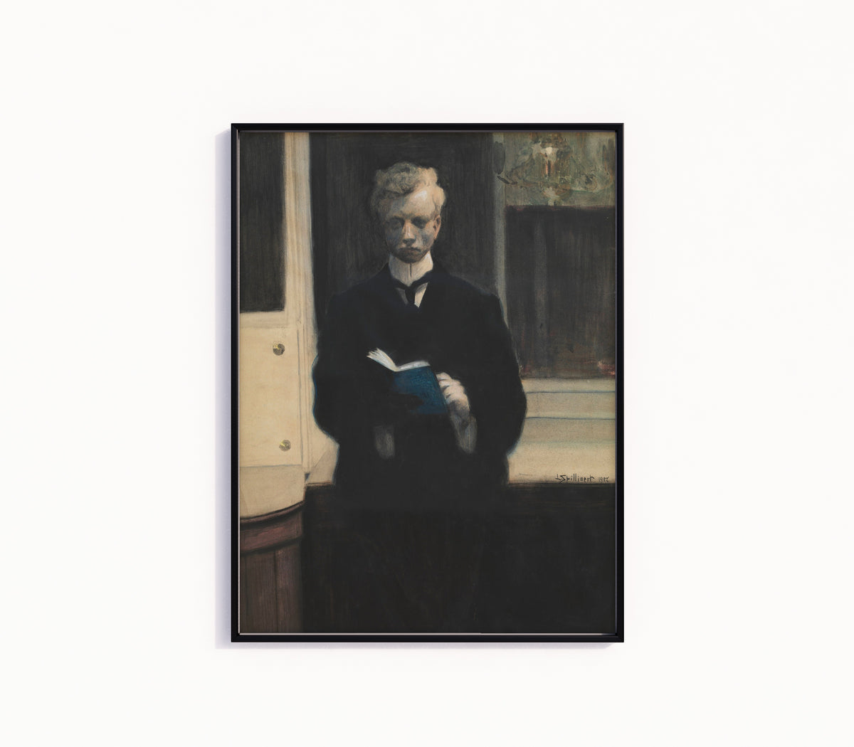 Framed art print of Self-Portrait with Blue Sketchbook by Léon Spilliaert, in a slim black frame on a plain white wall