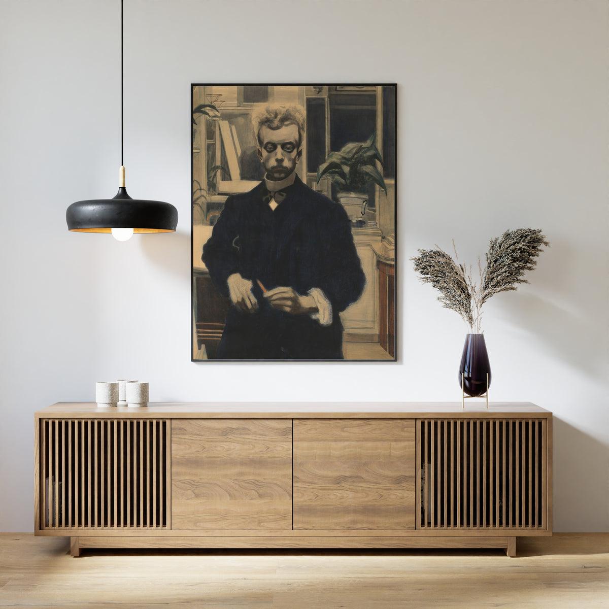 Framed art print of Self-Portrait with Red Pencil by Léon Spilliaert, above a slatted wood sideboard