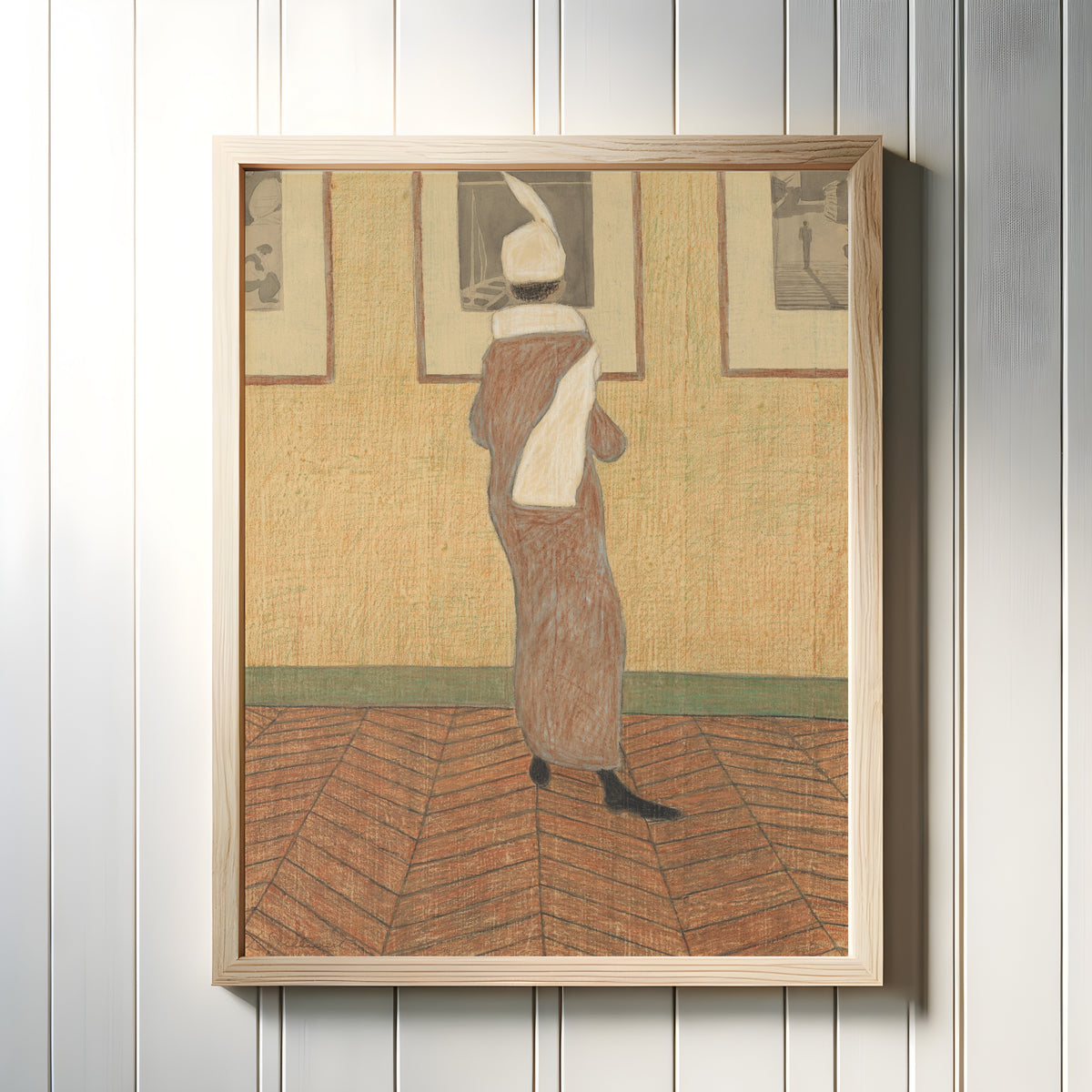 Framed art print of Woman at an Exhibition by Léon Spilliaert, in a light wood frame on a white panelled wall