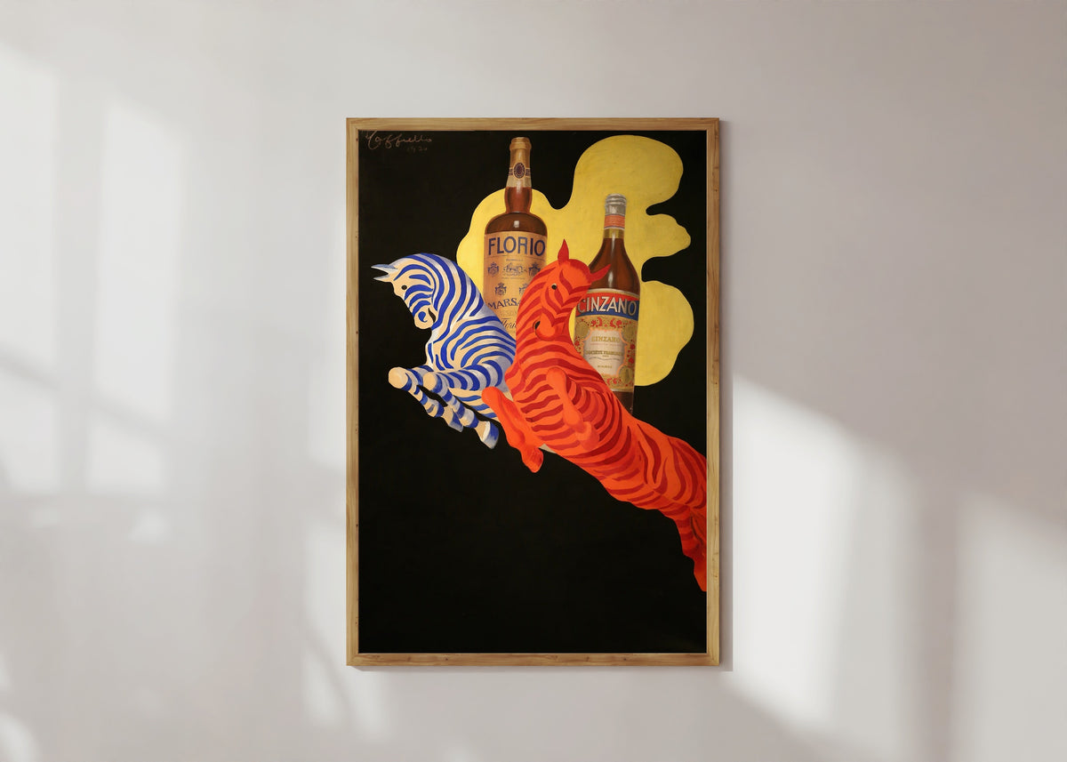 Framed art print of Florio Cinzano by Leonetto Cappiello, in a light wood frame on a sunlit white wall