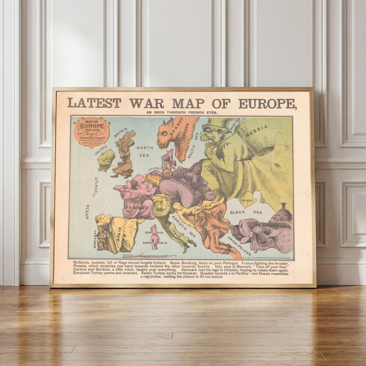 Framed art print of Latest War Map of Europe, as Seen Through French Eyes by Louis Prang & Co., in a light wood frame leaning against a panelled white wall