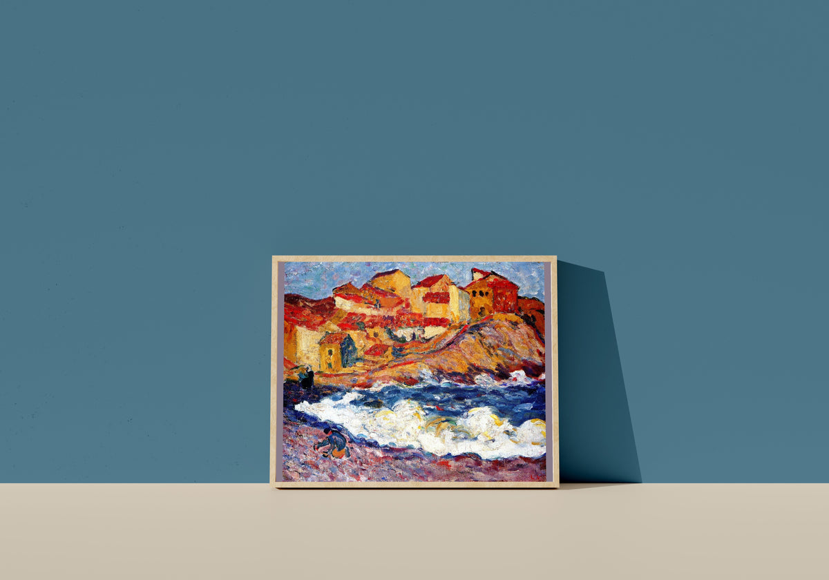 Framed art print of Village by the Sea by Louis Valtat, in a light wood frame leaning on a blue wall