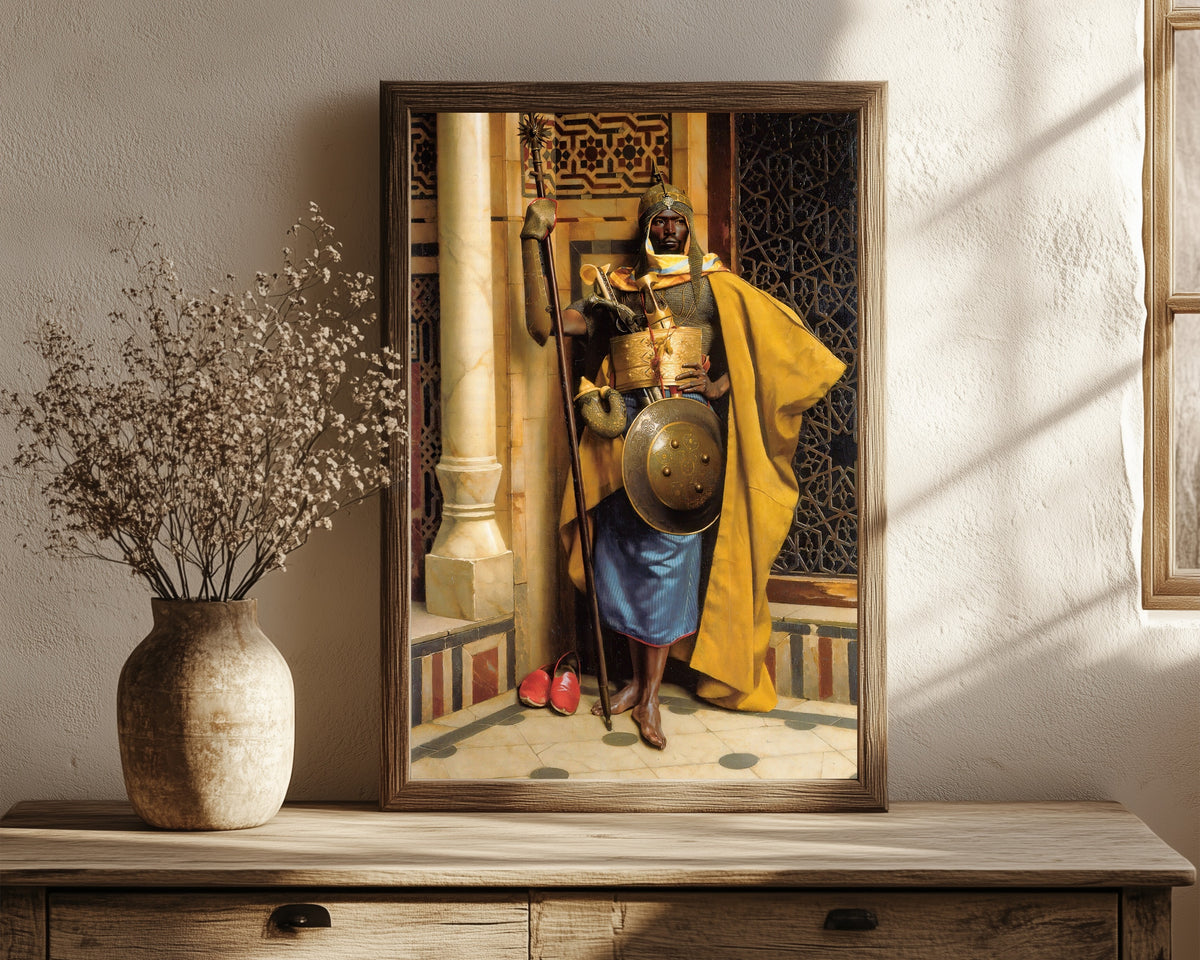 Framed art print of The Moorish Guard by Ludwig Deutsch, in a dark wood frame leaning on a rustic console beside dried flowers