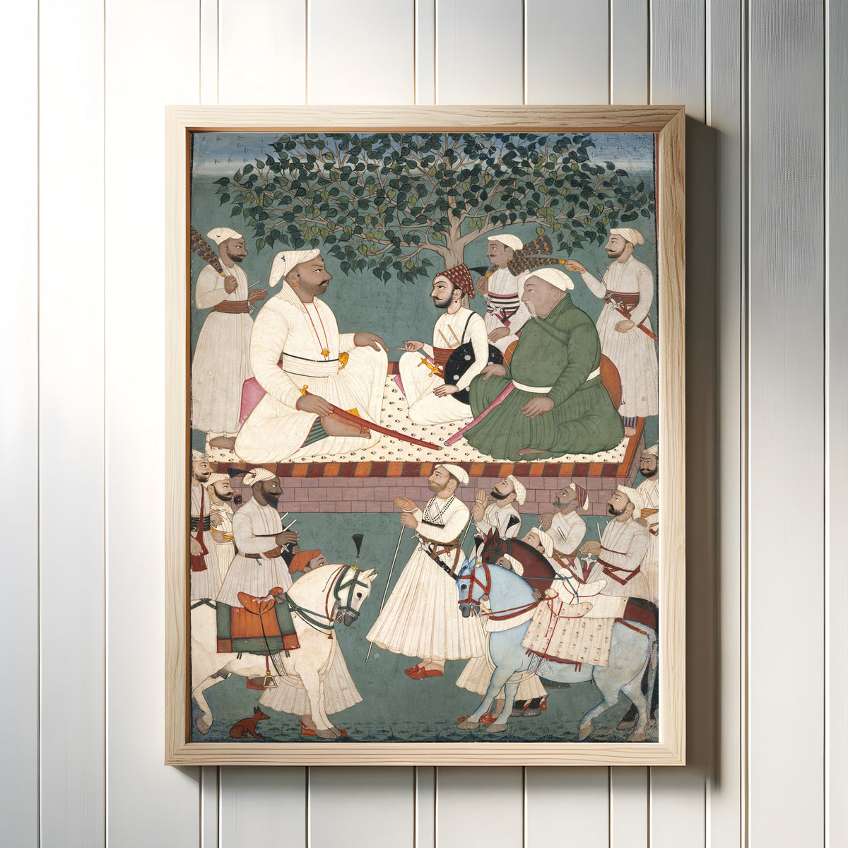 Framed art print of Maharaja Sidh Sen Receiving an Embassy by Mandi school, in a light wood frame on a white panelled wall