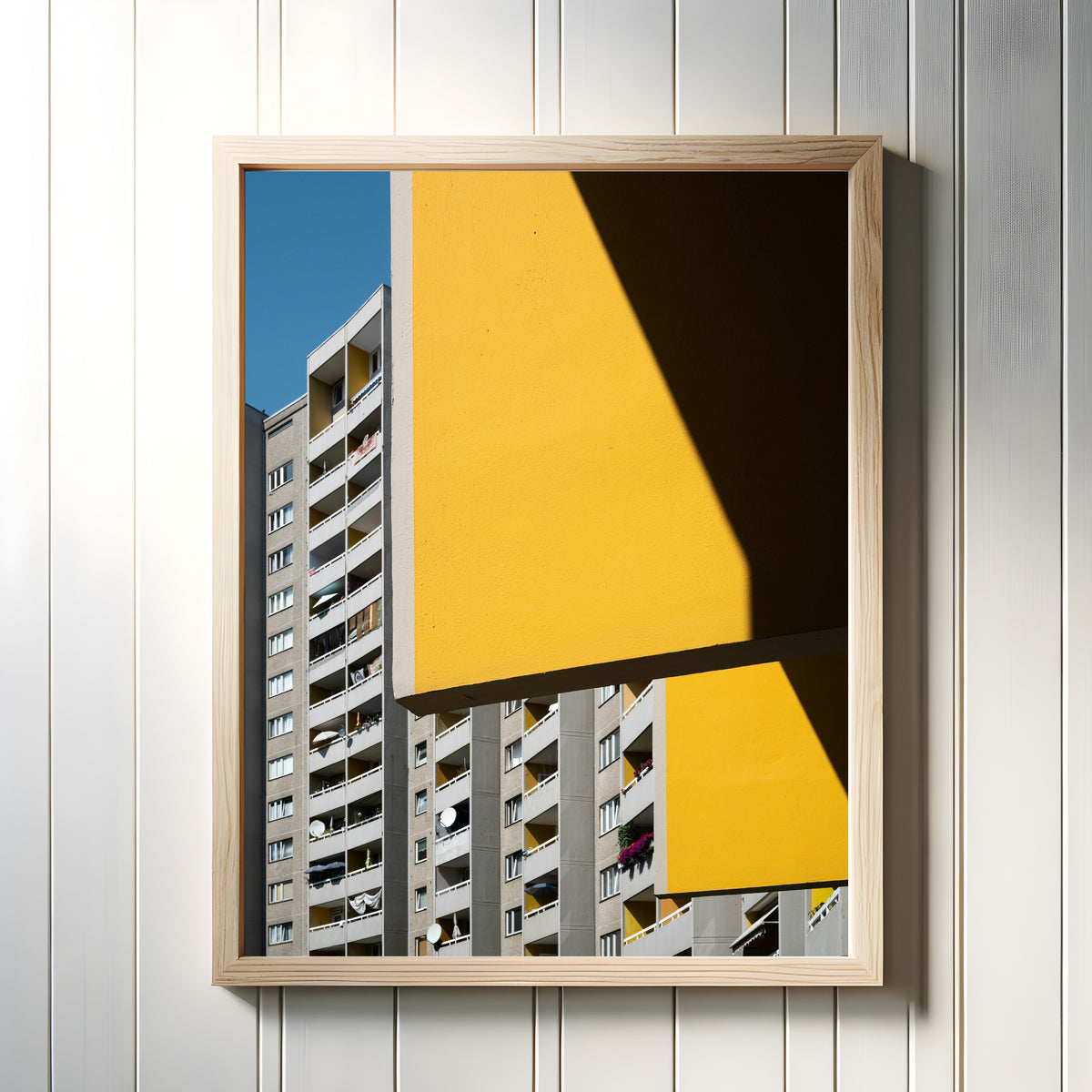 Framed art print of Light and Shadow VI by Marcus Lenk, in a light wood frame on a white panelled wall