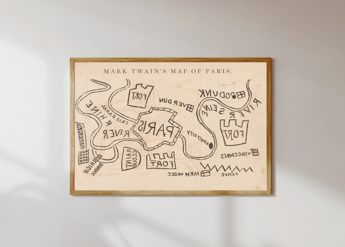 Framed art print of Mark Twain's Map of Paris by Mark Twain, in a light wood frame on a sunlit white wall