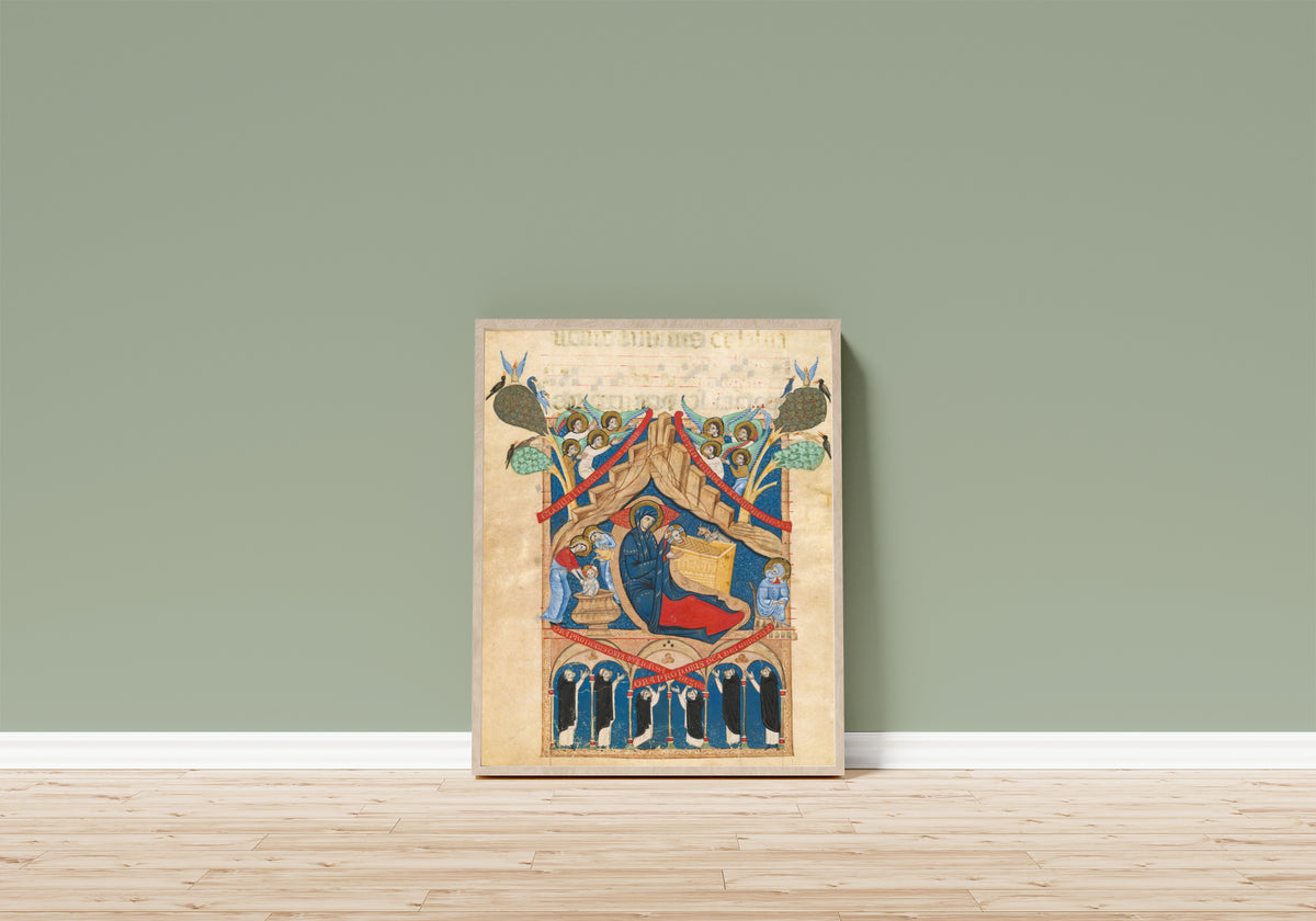 Framed art print of The Nativity with Six Dominican Monks by Master of Imola, in a light wood frame leaning on a sage green wall above a wooden floor