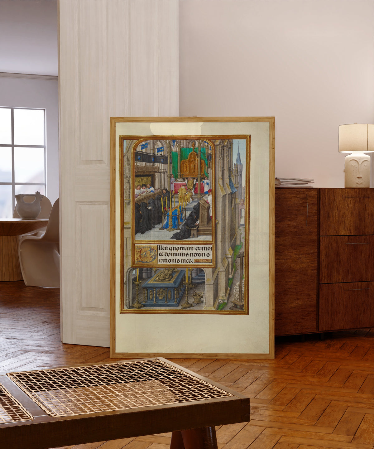 Framed art print of Spinola Hours: Office of the Dead by Master of James IV of Scotland, in a light wood frame leaning in a warm room with a parquet floor