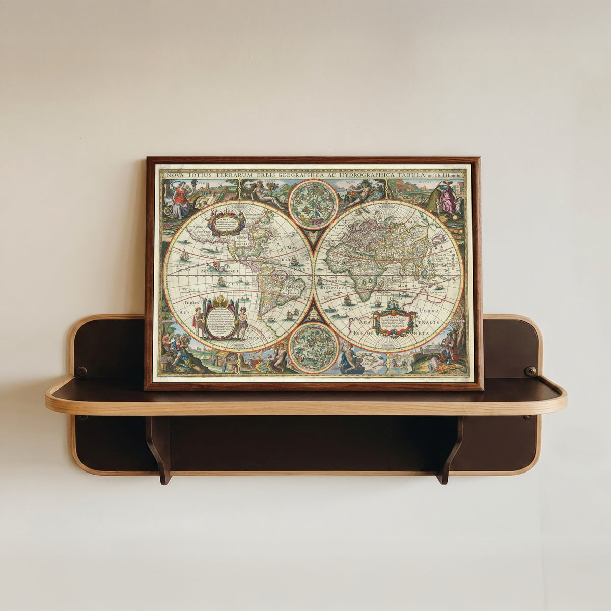 Framed art print of Nova Totius Terrarum Orbis Geographica ac Hydrographica Tabula by Melchior Tavernier II, in a dark wood frame resting on a wall shelf