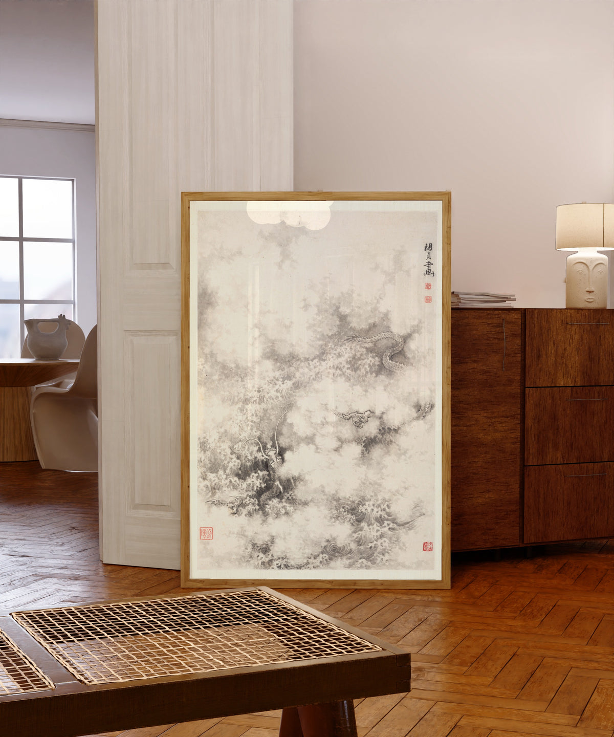 Framed art print of Dragon amid Clouds by Min Zhen, in a light wood frame leaning in a warm room with a parquet floor