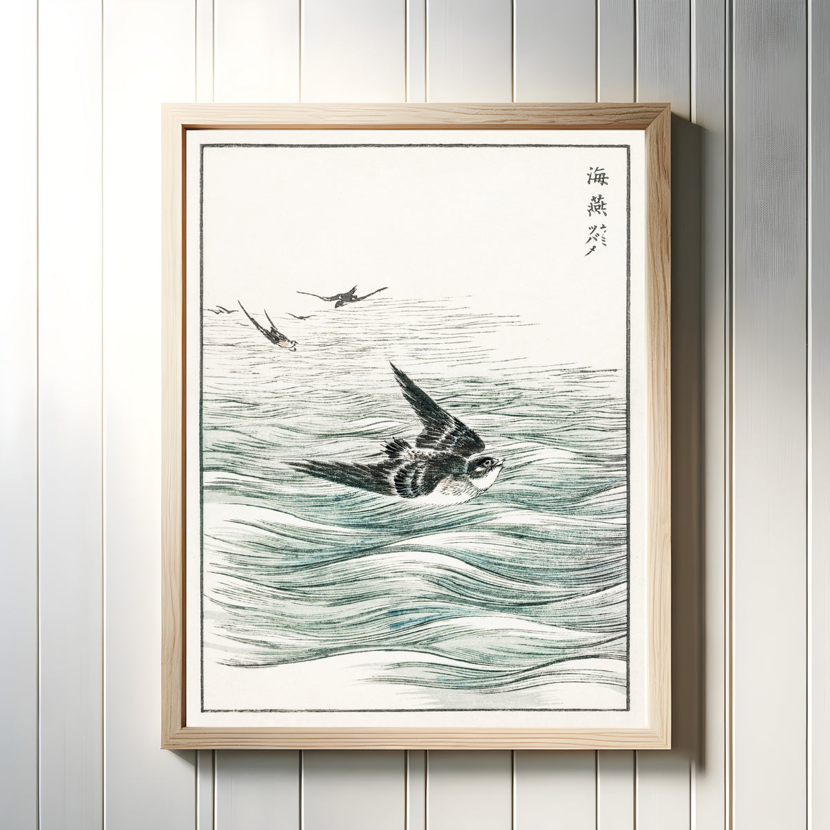 Framed art print of Riu Kiu House Swallow by Numata Kashū, in a light wood frame on a white panelled wall