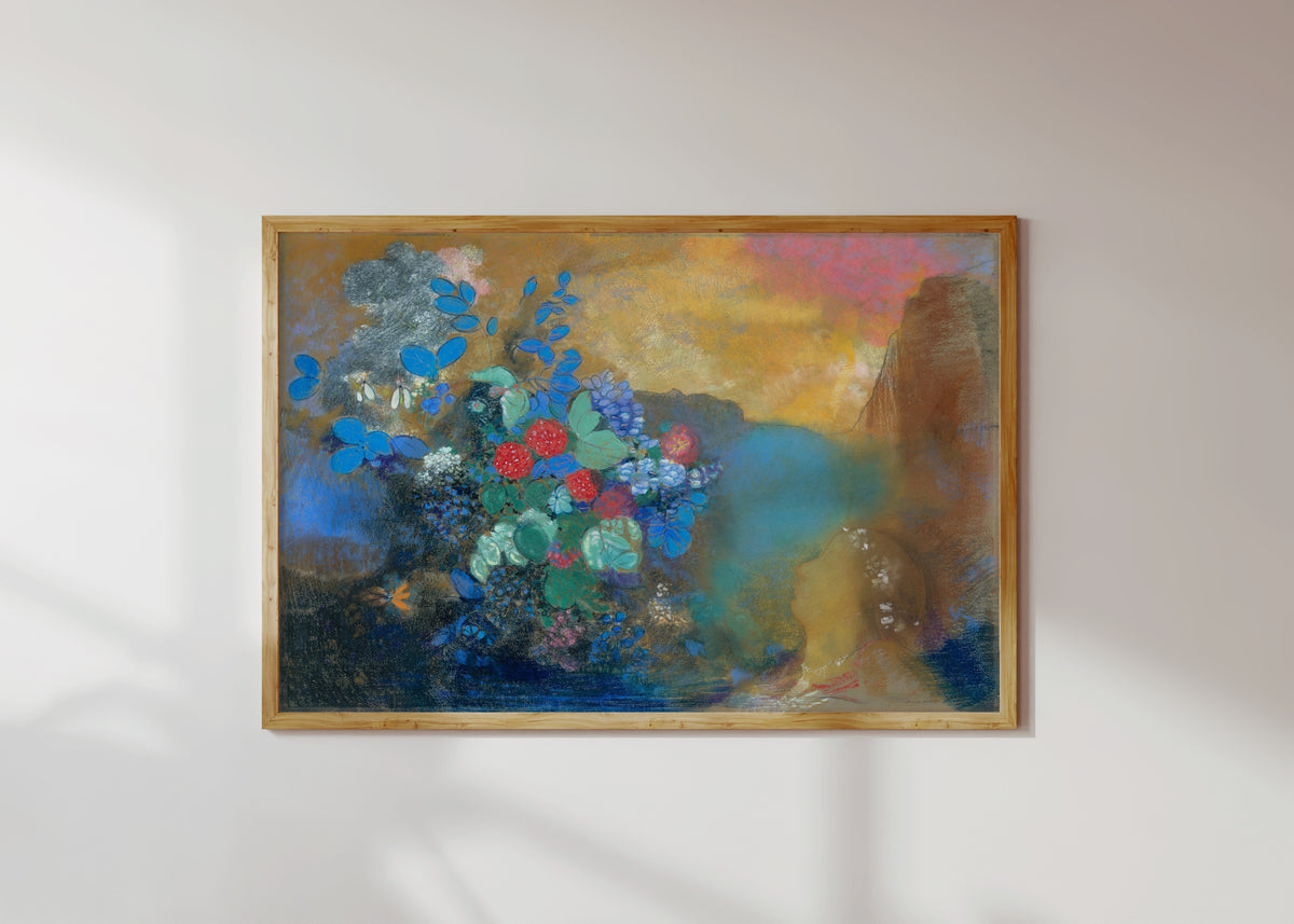 Framed art print of Ophelia Among the Flowers (c. 1905) by Odilon Redon, in a light wood frame on a sunlit white wall