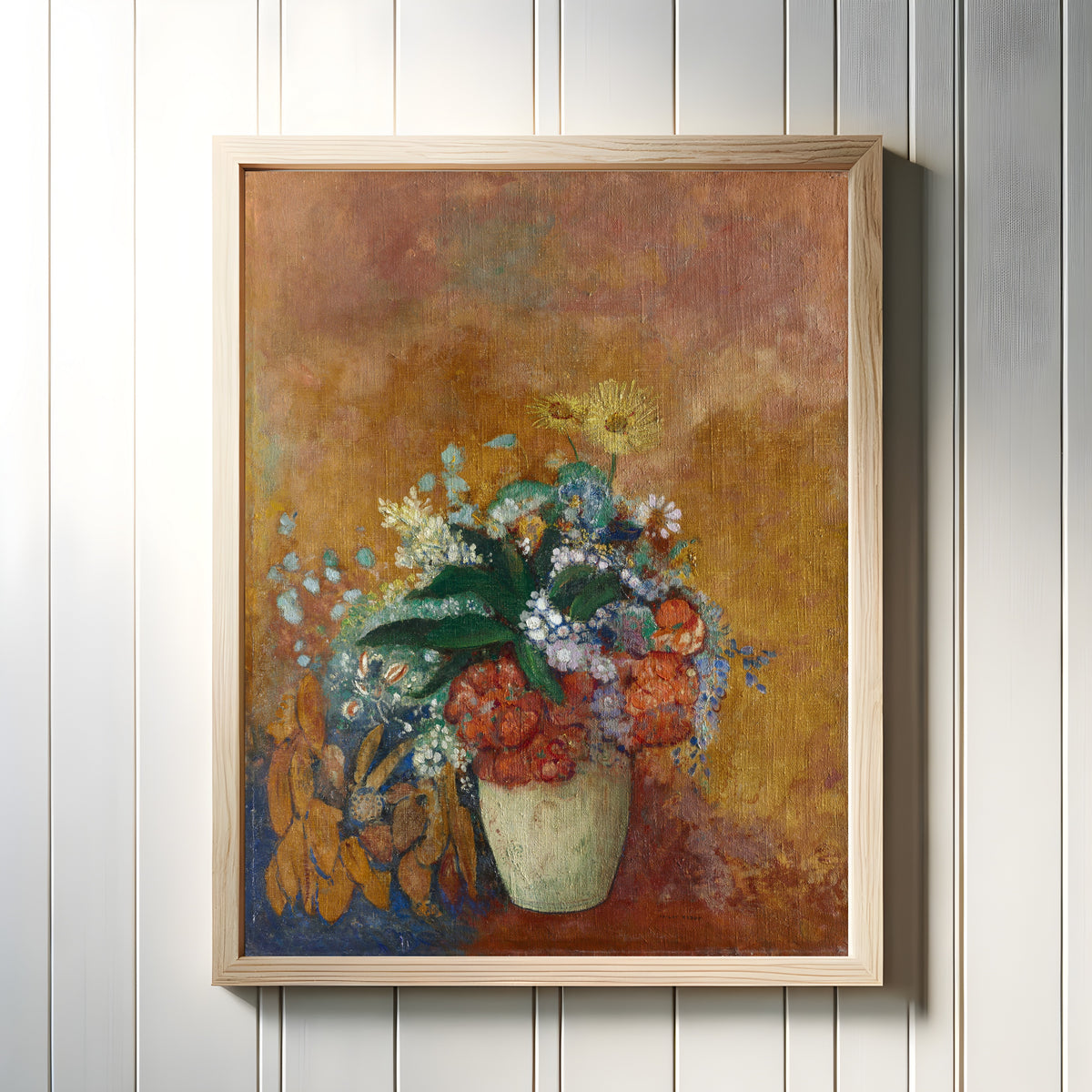 Framed art print of Vase of Flowers by Odilon Redon, in a light wood frame on a white panelled wall