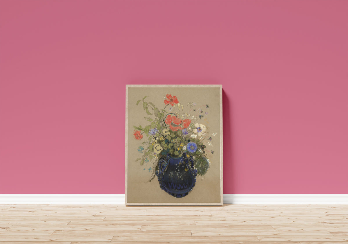 Framed art print of Vase of Flowers (Grey Background) by Odilon Redon, in a light wood frame leaning on a pink wall above a wooden floor