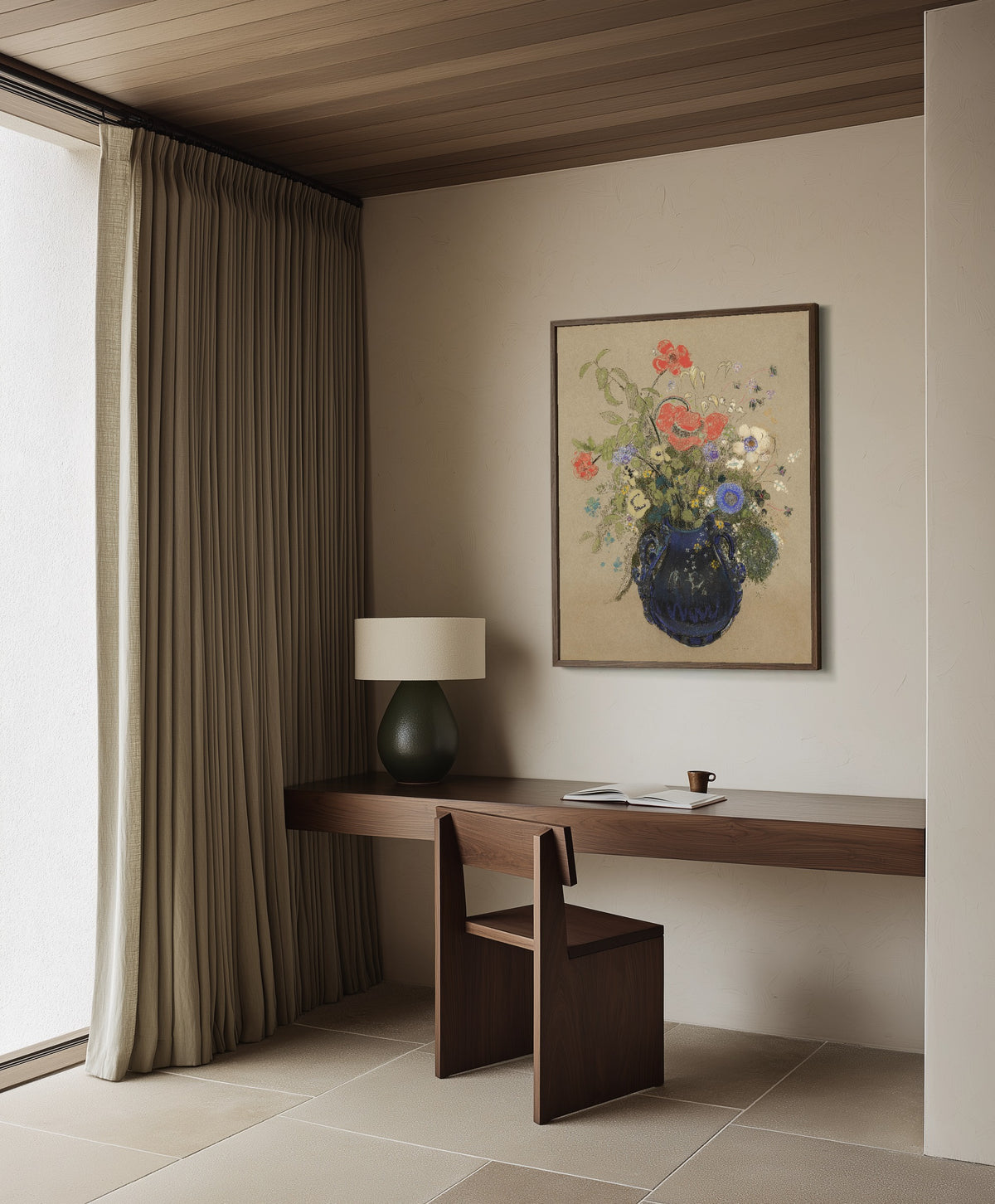 Framed art print of Vase of Flowers (Grey Background) by Odilon Redon, in a dark wood frame on a plaster wall above a walnut desk